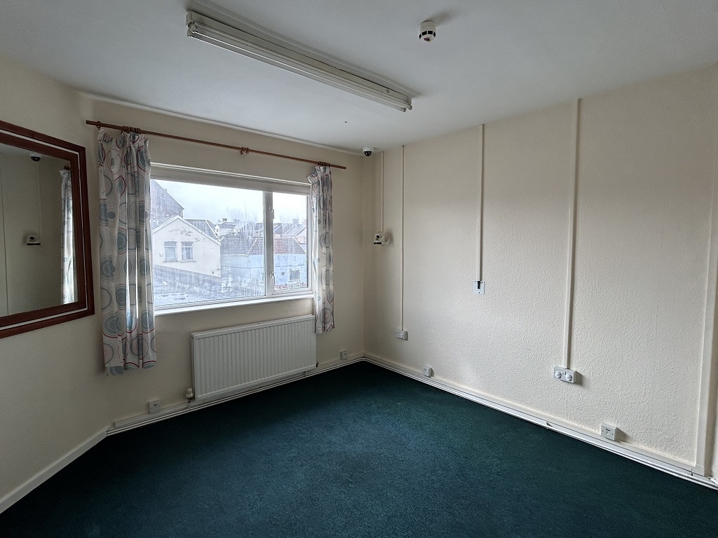 Internal view of an empty room with small window