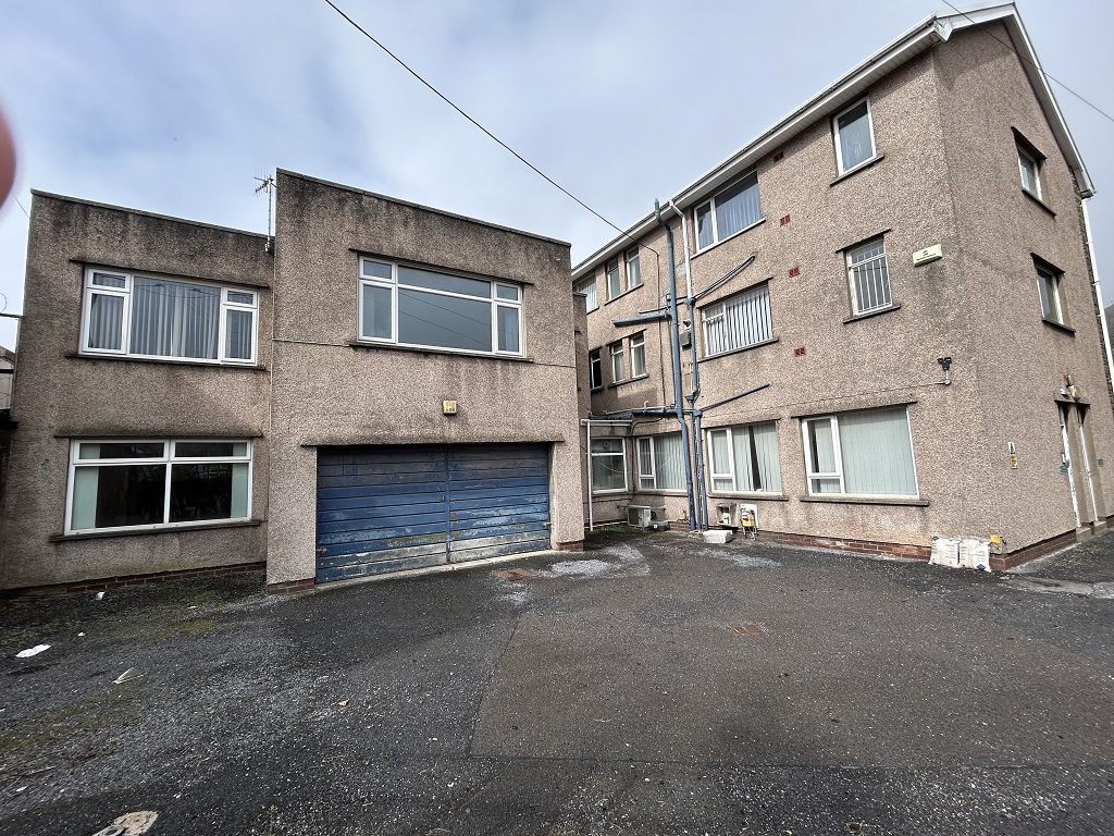 External view from behind the police station with view of garage door